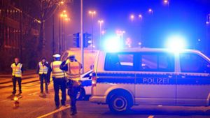 Sperrzone: Polizisten und Fahrzeuge der Polizei Düsseldorf sperren eine Straße in der Nähe der Fundstelle eines Fliegerbomben-Blindgängers im Düsseldorfer Stadtteil Rath. Foto: dpa