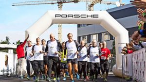 Der Vorstandsvorsitzende Oliver Blume (vorn, kurze Hose) und der Betriebsratsvorsitzende Uwe Hück (links daneben) starten den Spendenlauf von der Pole-Position. Foto: Porsche