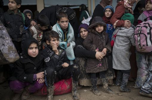 Frauen und Kinder in Mossul warten darauf, in ein Flüchtlingslager im Westen der Stadt gebracht zu werden. Foto: AP