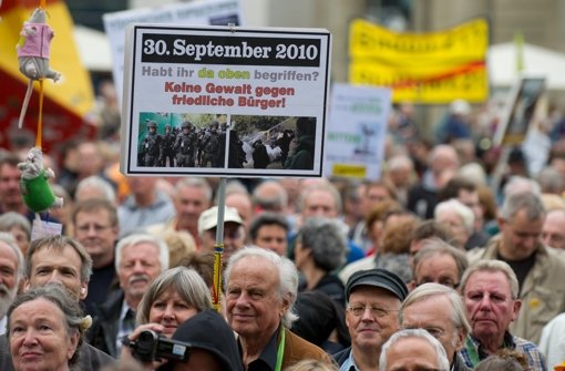 Stuttgart 21-Gegner halten am 29. September auf dem Schlossplatz in Stuttgart während einer Kundgebung Plakate und Transparente in den Händen. Mehrere tausend Menschen demonstrierten gegen den ungewöhnlich harten Polizeieinsatz. Foto: dpa