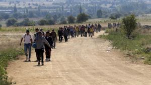 Flüchtlinge laufen von der mazedonischen Grenze nach Serbien. Foto: AP