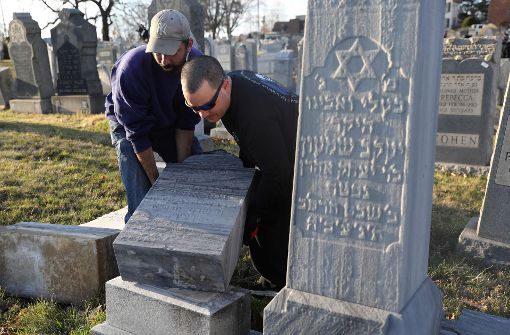 Erneute Aufrichtung eines Grabsteins: Auf einem jüdischen Friedhof in Philadelphia wurden Gräber geschändet. Foto: AFP