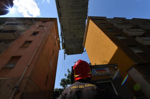 Ein Feuerwehrmann schaut auf die Überreste des Polcevera-Viadukt in Genua. Am 14. August 2018 stürzte um 11.30 Uhr  ein Teil der Brücke von etwa 250 Metern Länge rund um den westlichen Pylon ein. Dabei starben mindestens 40 Menschen. Foto: AP