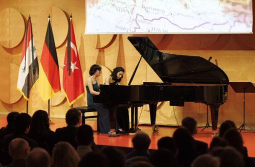 Vor den Flaggen der Türkei, Deutschland und Syrien präsentiert das Klavierduo Motus im Hospitalhof Werke von Brahms, Schubert und Yildirim. Foto: Lichtgut/Julian Rettig