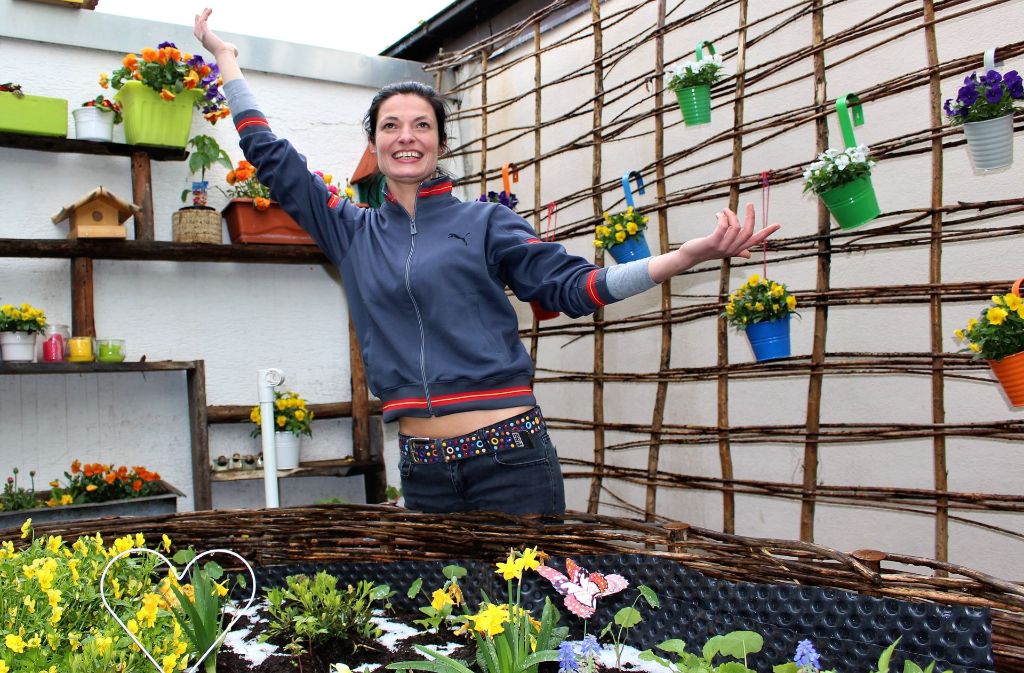 Nele Bonner, die Leiterin der Awo-Begegnungsstätte an der Osterbronnstraße 64 B, freut sich über die vielen bunten Blumen auf der Terrasse. Foto: Caroline Holowiecki