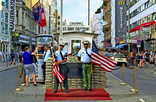 Falsche Soldaten posieren für ein Foto mit Touristen. Das kostet natürlich Geld  – wie alles am Checkpoint Charlie. Foto: Konrad Hädener/Flickr
