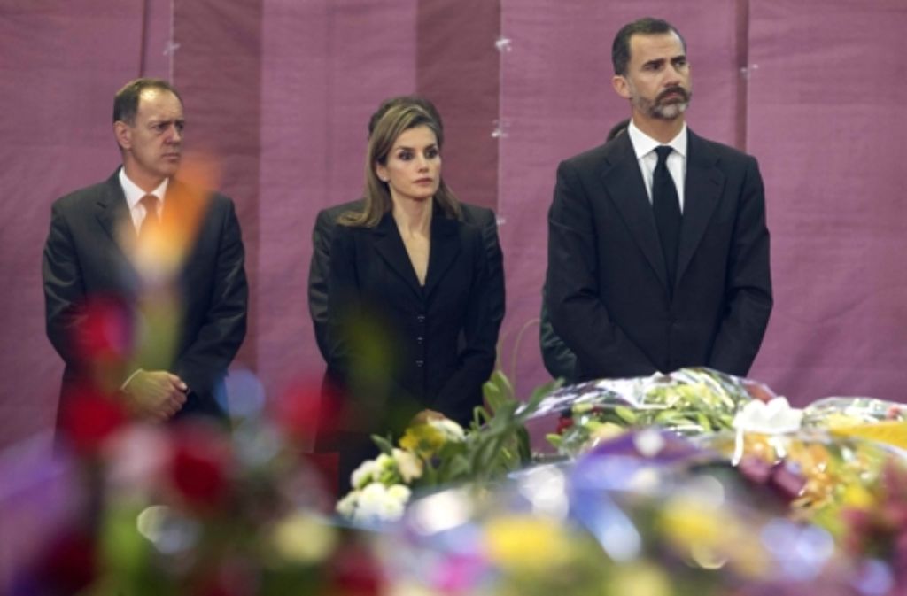 König Felipe von Spanien (rechts) und seine Frau Letizia nehmen an der Abschiedszeremonie vor der Beerdigung der 14 Opfer des schweren Busunglücks teil.