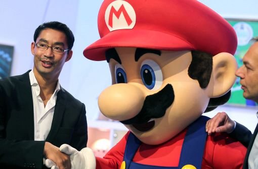 Bundeswirtschaftsminister Philipp Rösler wird auf der Gamescom vom Nintendo-Helden Supermario begrüßt. Foto: dpa