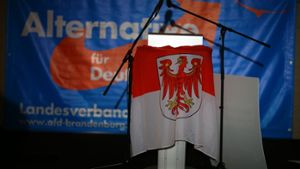 Eine Fahne des Landes Brandenburg vor einem AfD-Plakat. Foto: dpa