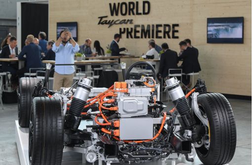 Das Fahrgestell mit den Elektroantrieben des Porsche Taycan wird auf der Weltpremiere  in einer Halle auf einem Flugplatz in Brandenburg gezeigt. Foto: dpa/Patrick Pleul