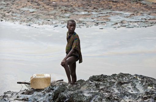 Ein Junge steht am Ufer eines ölverschmutzten Baches in der Nähe von Goi in Nigeria (Archivbild) Foto: ANP/EPA/dpa/Marten Van Dijl