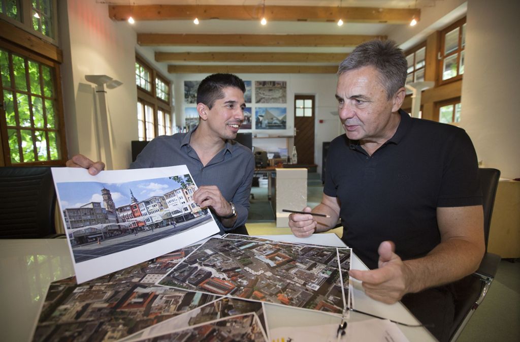Mustafa Rasch (links) und Jürgen  Bradatsch mit Skizzen die zeigen, wie der Marktplatz mit großen Schirmen aussehen würde.