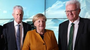 Dietmar Hopp (links), Angela Merkel und Winfried Kretschmann beim Treffen in Sinsheim. Foto: AFP/DANIEL ROLAND