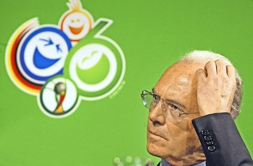 Franz Beckenbauer, OK-Chef 2006, vor dem WM-Logo: Aus heutiger Sicht entbehrt das Motto nicht einer gewissen Ironie: „Zu Gast bei Freunden“.  Foto: AP